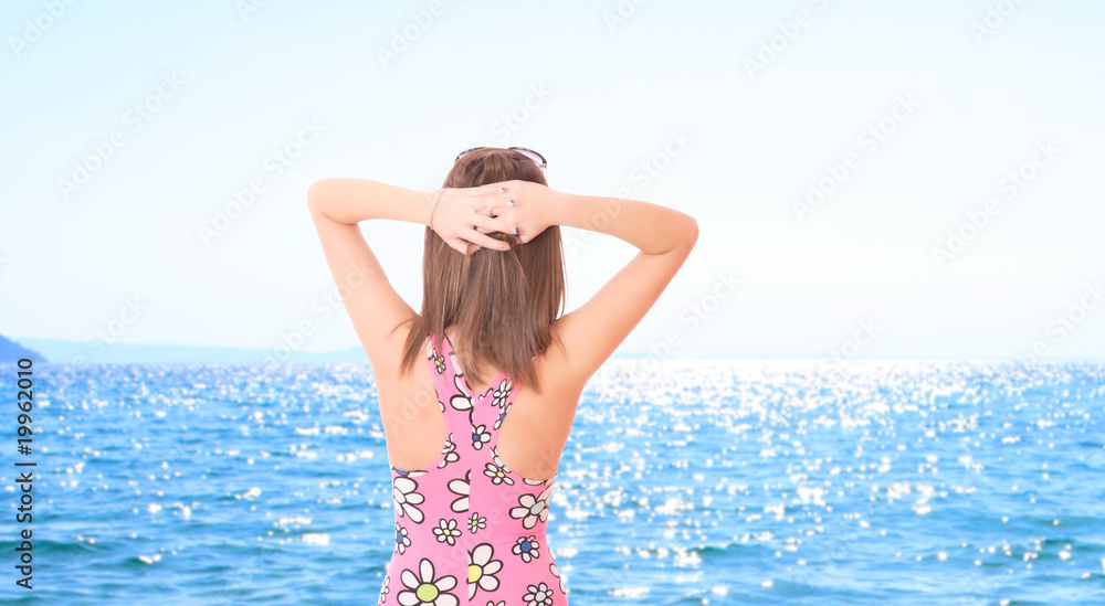 Beautiful young woman relaxing by the beach Beautiful young woman relaxing by the beach