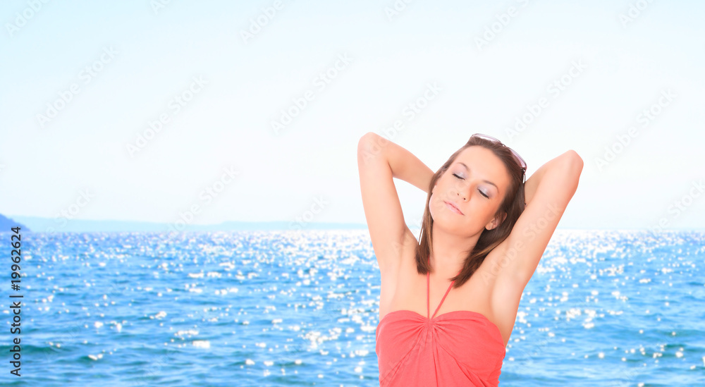 Beautiful young woman relaxing by the beach Beautiful young woman relaxing by the beach