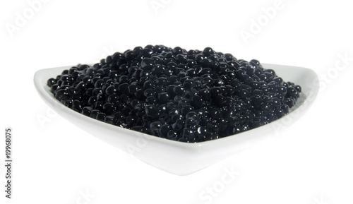 Black caviar in a white plate. (Acipenser)