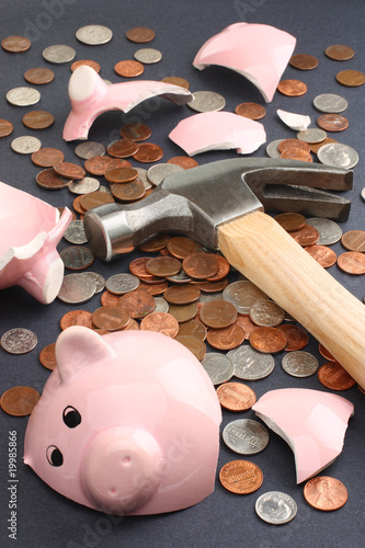 A broken piggy bank loaded with dollar coins