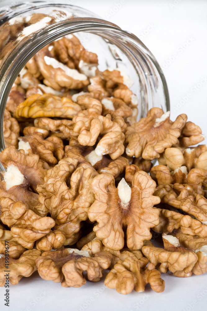 walnuts in Glass Jar isolated on the white background walnuts in Glass Jar isolated on the white background