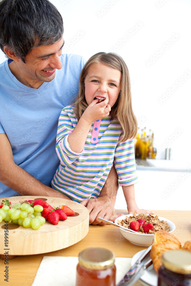 Jolly father and his daughter having breakfast Jolly father and his daughter having breakfast