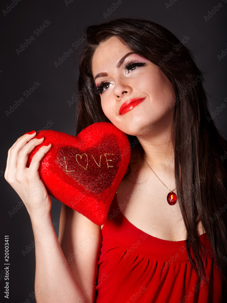 Girl with red heart on grey background. Valentine's Day. Girl with red heart on grey background. Valentine's Day.