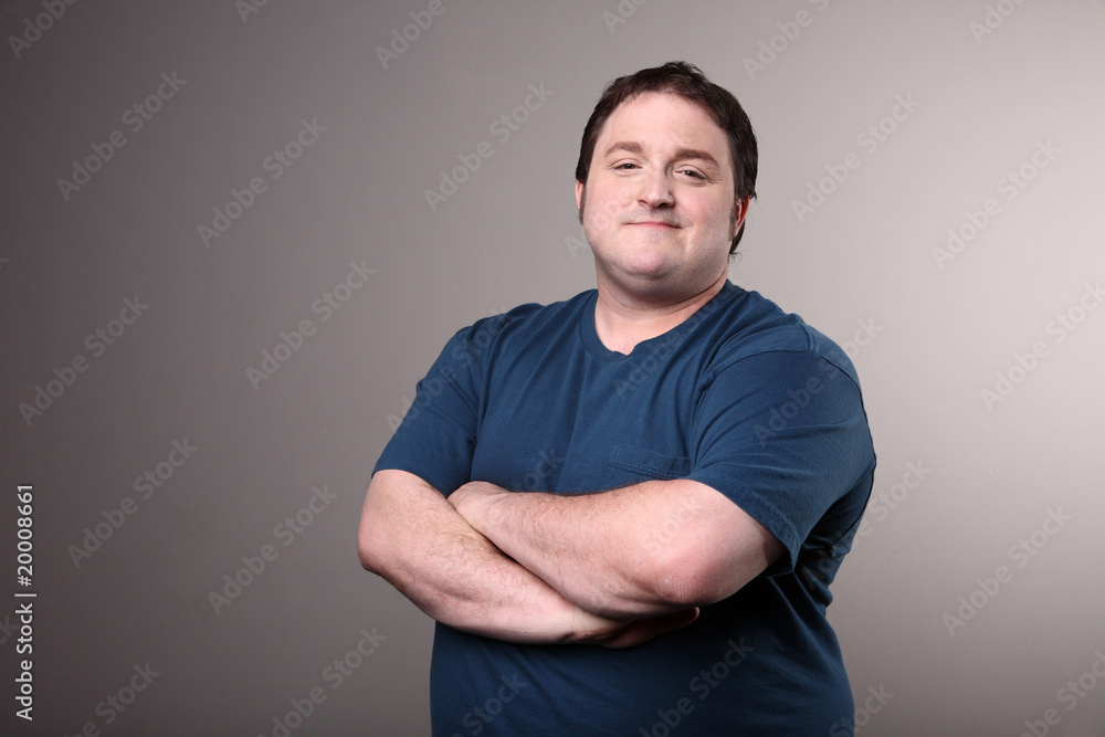 Portly man with arms crossed. Stock Photo Adobe Stock