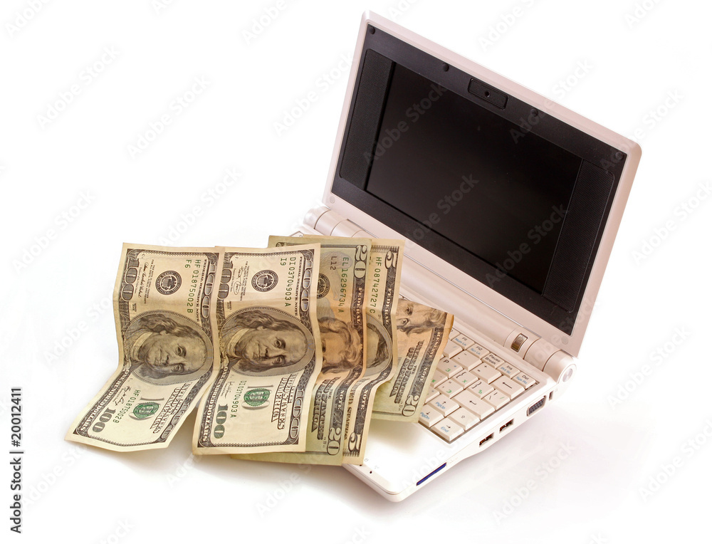 Concept with dollars and white laptop isolated on white Concept with dollars and white laptop isolated on white