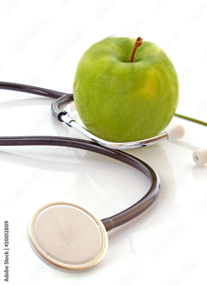 Stethoscope and green apple on white background Stethoscope and green apple on white background