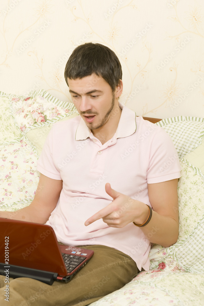 Picture of young handsome man working online from his house on t Picture of young handsome man working online from his house on t