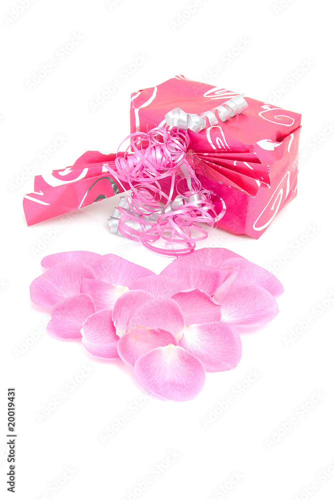 beautiful wrapped gift with rose leaves in heart shape beautiful wrapped gift with rose leaves in heart shape