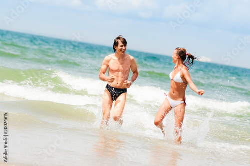 Young happy couple on the beach