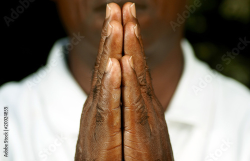 fingers of afro man in prayer