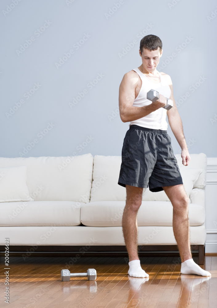 Man Using Arm Weights in Living Room Man Using Arm Weights in Living Room