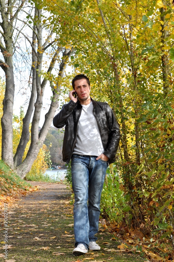 Young man on the phone in the countryside