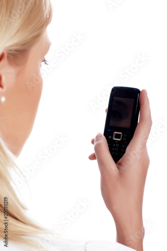 charming blonde businesswoman in a white shirt with phone