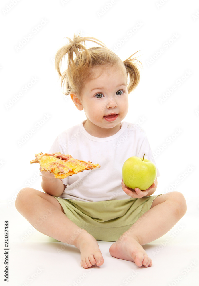 Baby girl with green apple and pizza Baby girl with green apple and pizza