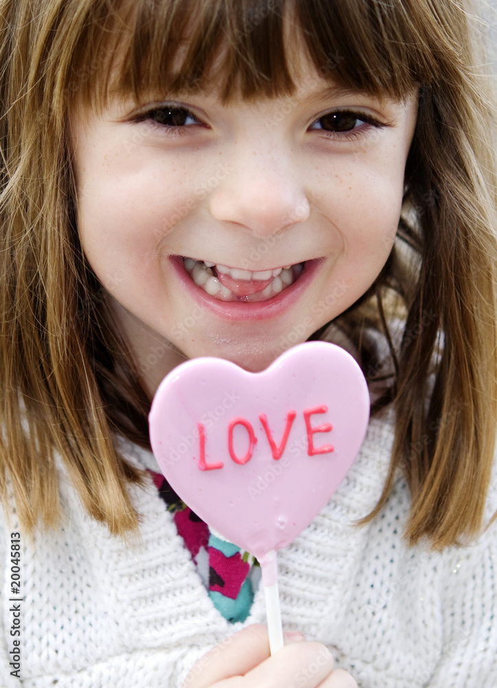 Adorable smiling little girl holding lollypop Adorable smiling little girl holding lollypop