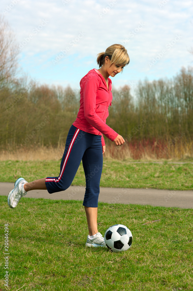 Sportswoman Kicking a Ball Sportswoman Kicking a Ball