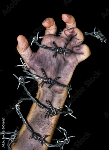 hand grabbing a barbed wire