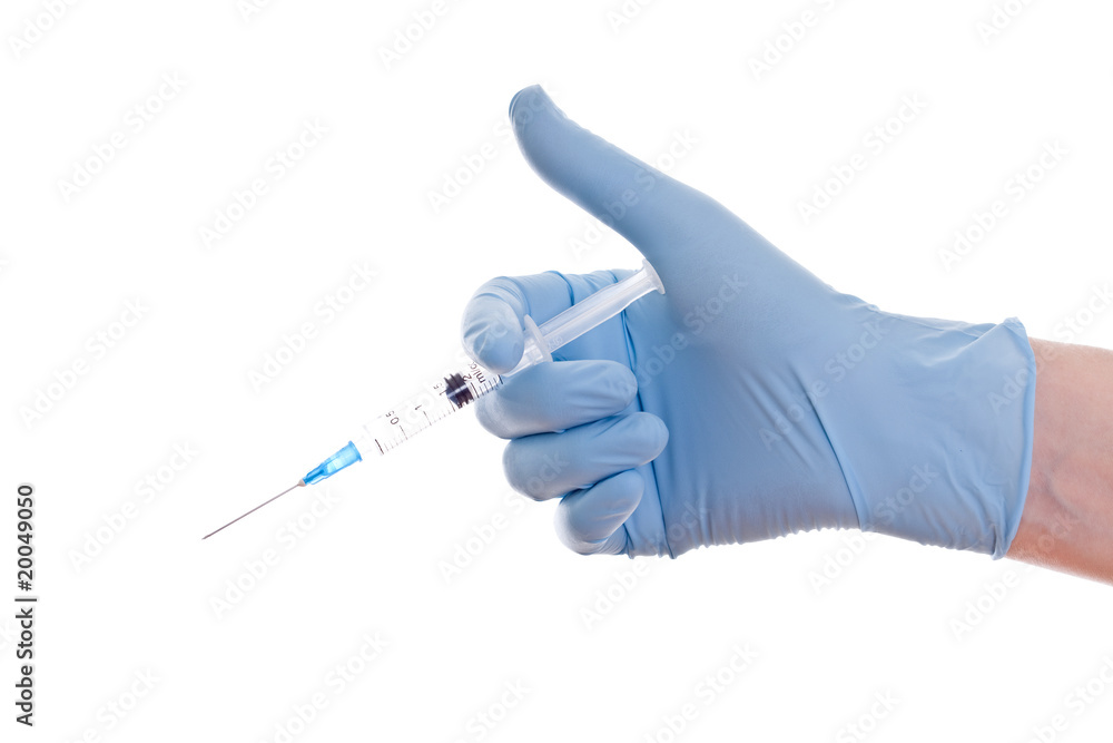 The hands in the medical gloves and the syringe in them The hands in the medical gloves and the syringe in them