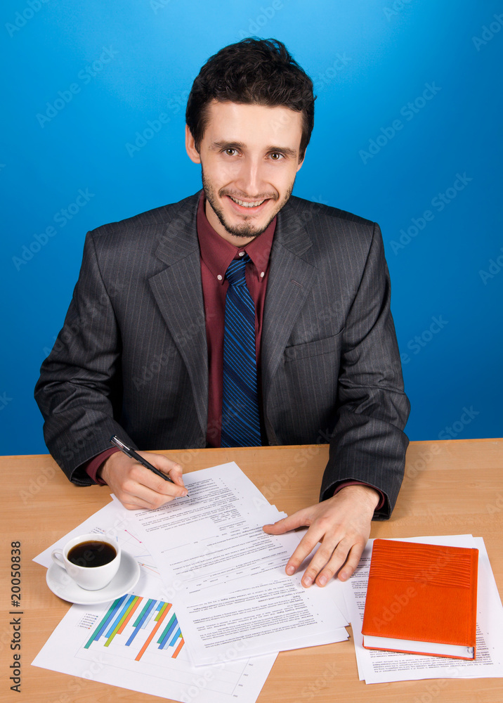 Young handsome businessman working with documents Young handsome businessman working with documents
