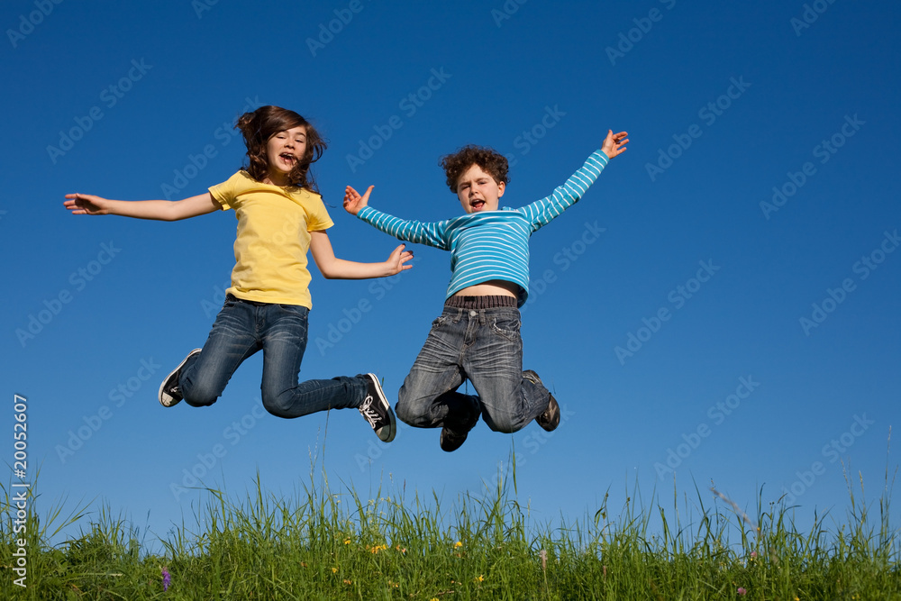 Kids jumping, running against blue sky Kids jumping, running against blue sky