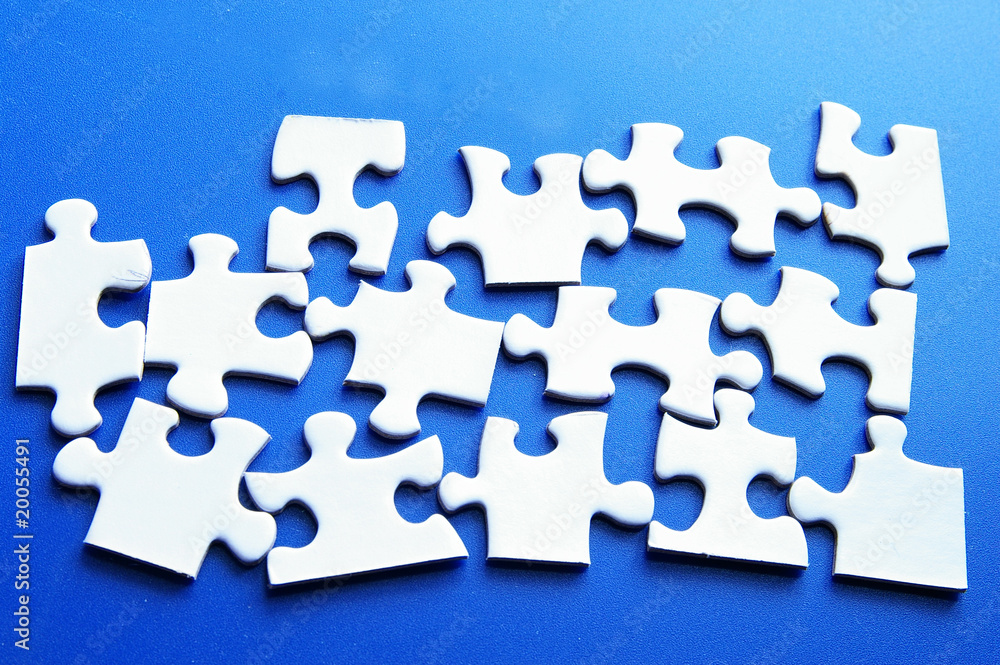 assorted white puzzle pieces on blue surface assorted white puzzle pieces on blue surface