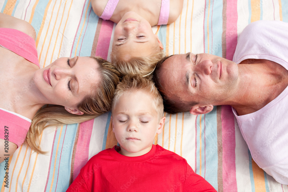 Tired family sleeping lying on the grass