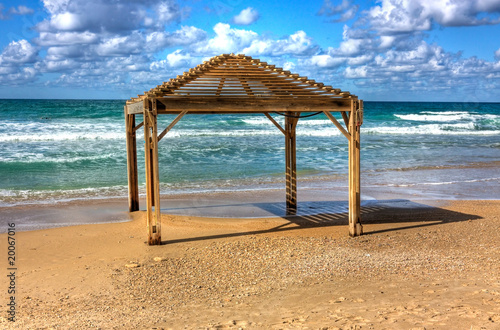Fototapeta Naklejka Na Ścianę i Meble -  Sea shore and wooden sun shelters – Netanya, Israel