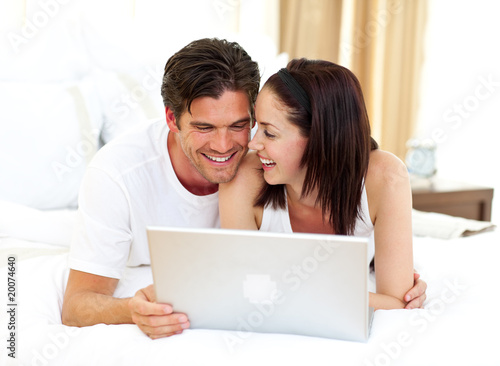 Enamoured couple using laptop