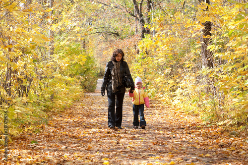 Mother and daughter walk on foot on autumnal park © Pavel Losevsky