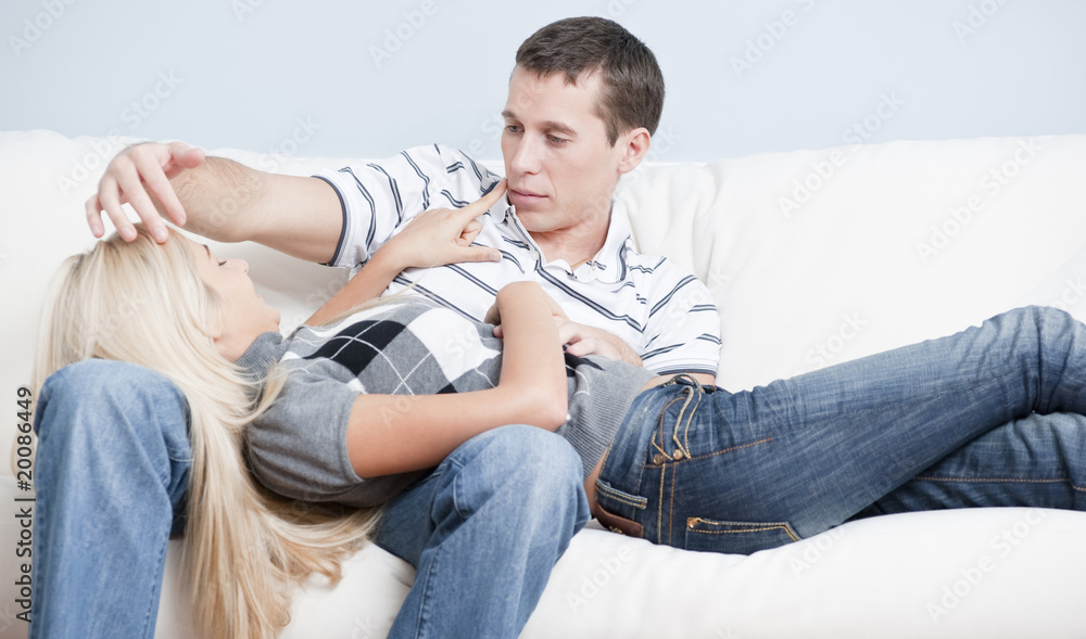 Affectionate Couple Relaxing Together on Couch Affectionate Couple Relaxing Together on Couch