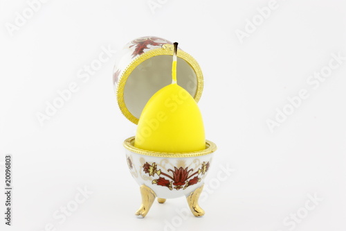Egg a casket white with yellow wax a candle separately on a whit