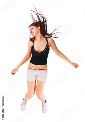 Excited young girl jumping on white