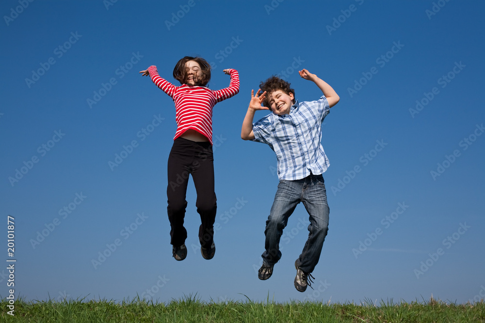 Kids jumping, running against blue sky Kids jumping, running against blue sky