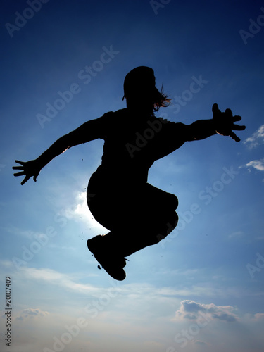 silhouette of a young man jumping