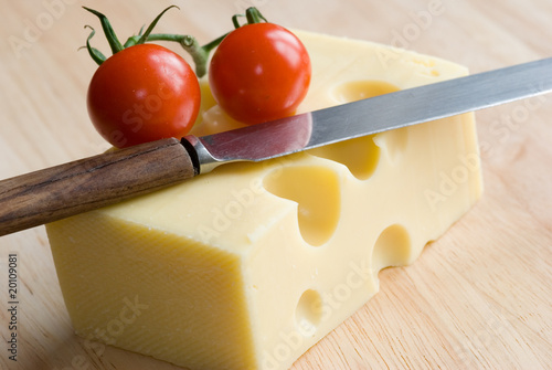 Emmental cheese with cherry tomatoes and knife
