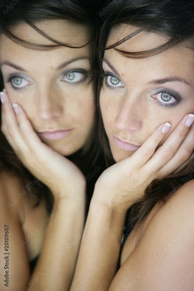 Beautiful woman on the mirror as a twins portrait Beautiful woman on the mirror as a twins portrait