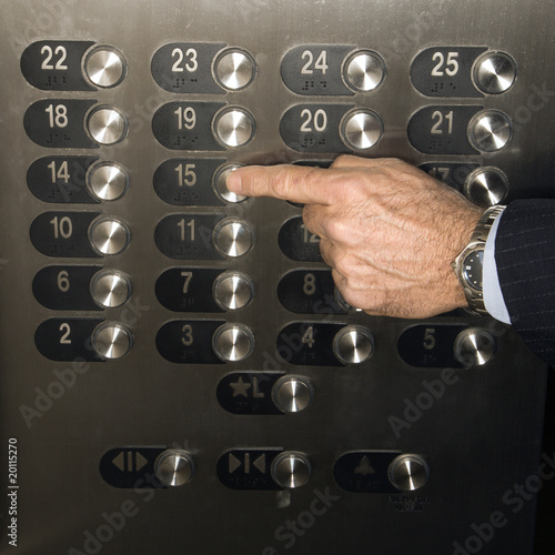 Hand Pushing Elevator Button photo