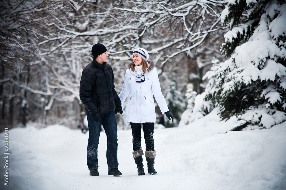 Young beautiful couple walks on winter steam Young beautiful couple walks on winter steam