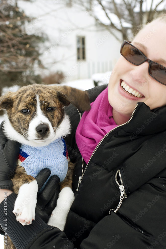 Girl Holding Dog in Sweater Girl Holding Dog in Sweater