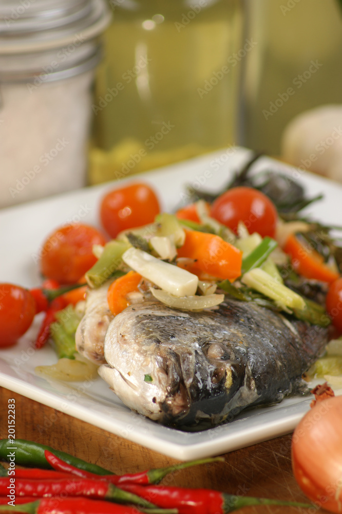 see bream with mediterranean vegetable on a plate