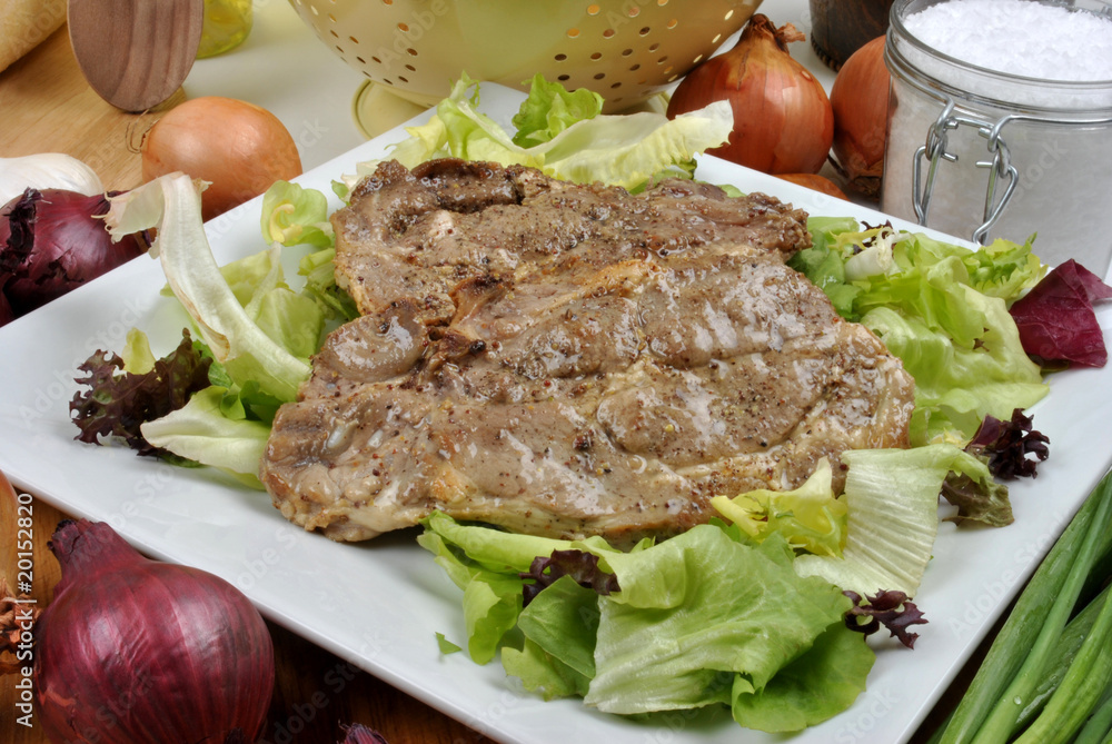 spare rib chops on a plate with salad
