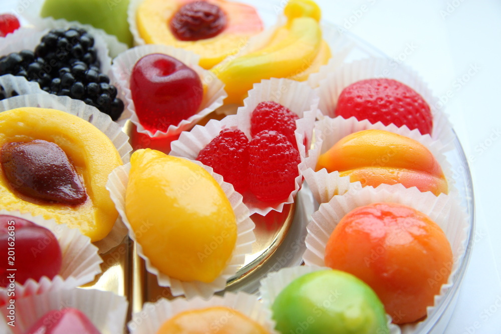 Candies in the form of fruits on a white background Candies in the form of fruits on a white background