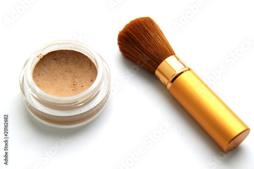 Brush for a make-up and powder on a white background