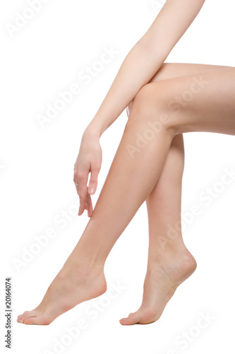 hand touching the beautiful naked woman legs