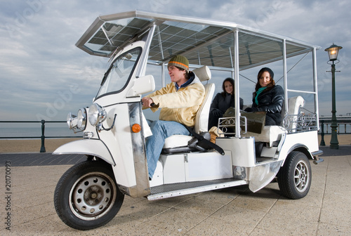 Solar powered tuc tuc at the beach photo