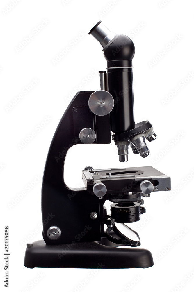 old microscope on white old microscope on white