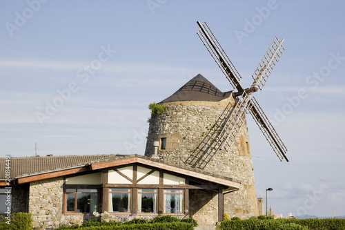 image of a windmill building over a blue sky