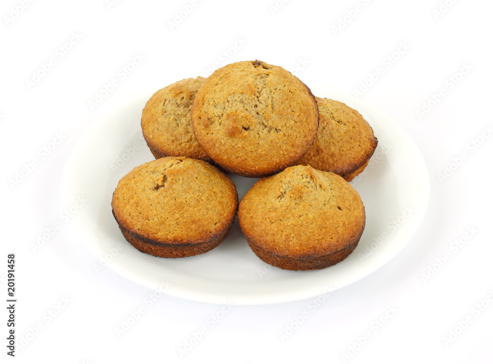 Fresh baked bran muffins on white plate