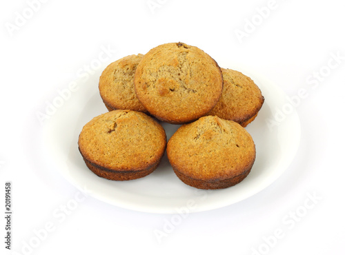 Fresh baked bran muffins on white plate