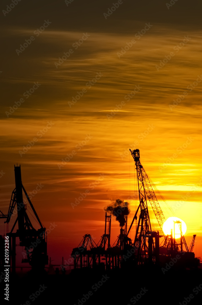 Sunset over industrial harbor